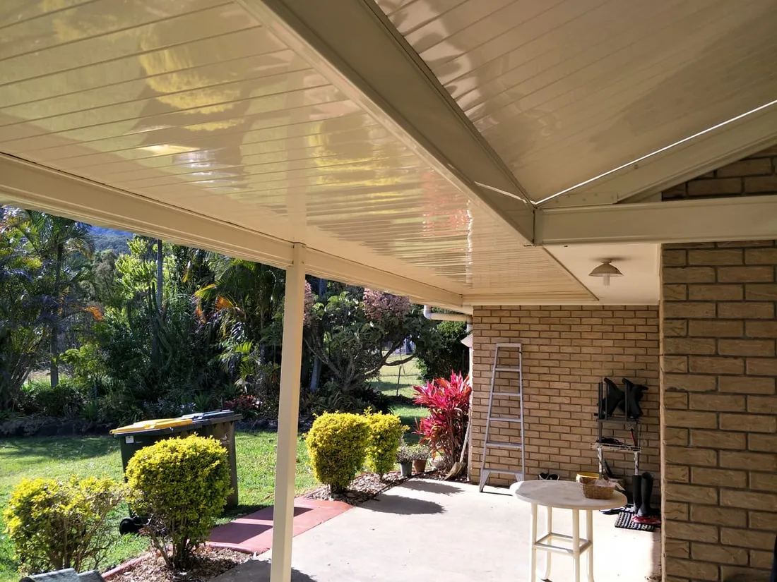 Insulated patio with ceiling fan over a brick home's outdoor area, Dam Good Patios