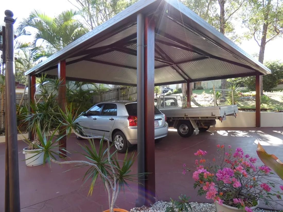 Timber-post gable carport sheltering two vehicles