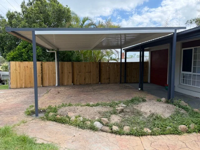 Flat-roof double carport beside a brick home in South East Queensland