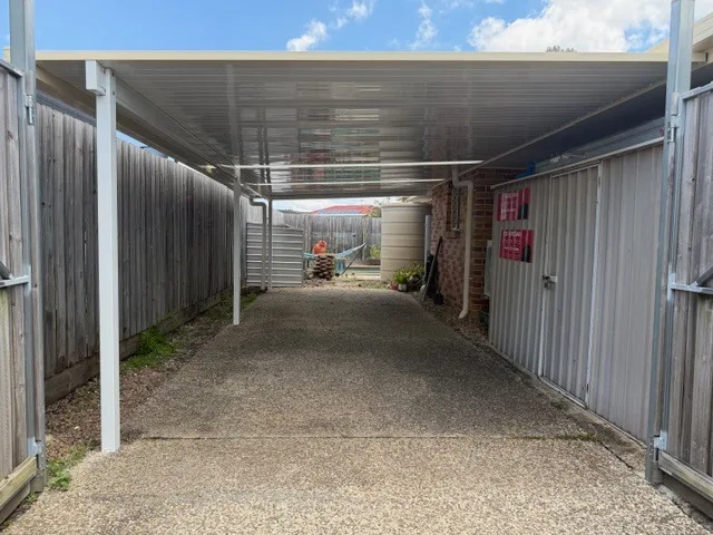 Flat-roof carport beside a brick home in South East Queensland