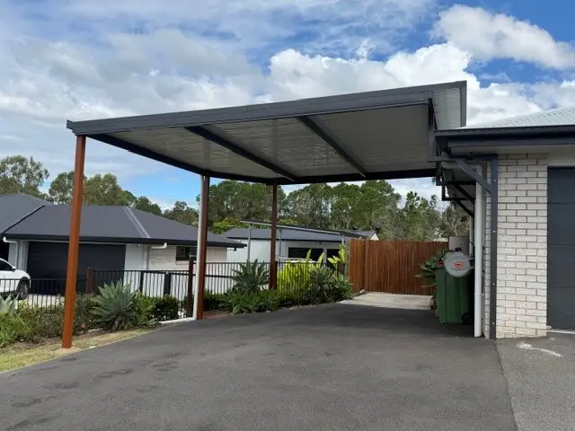 Skillion-roof carport beside a brick home in South East Queensland